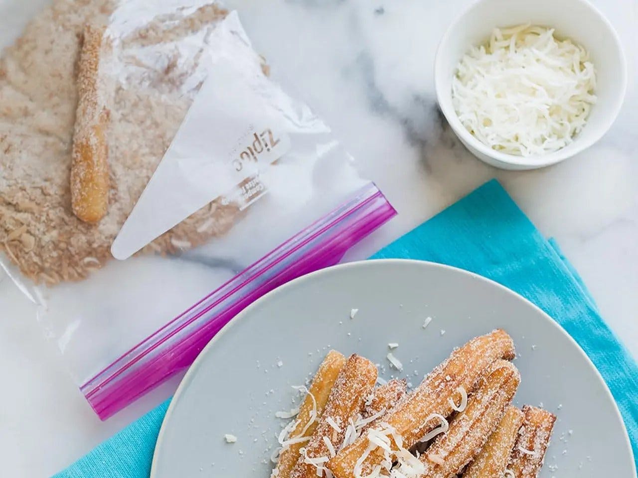 Churros with cinnamon coconut sugar topping on plate.