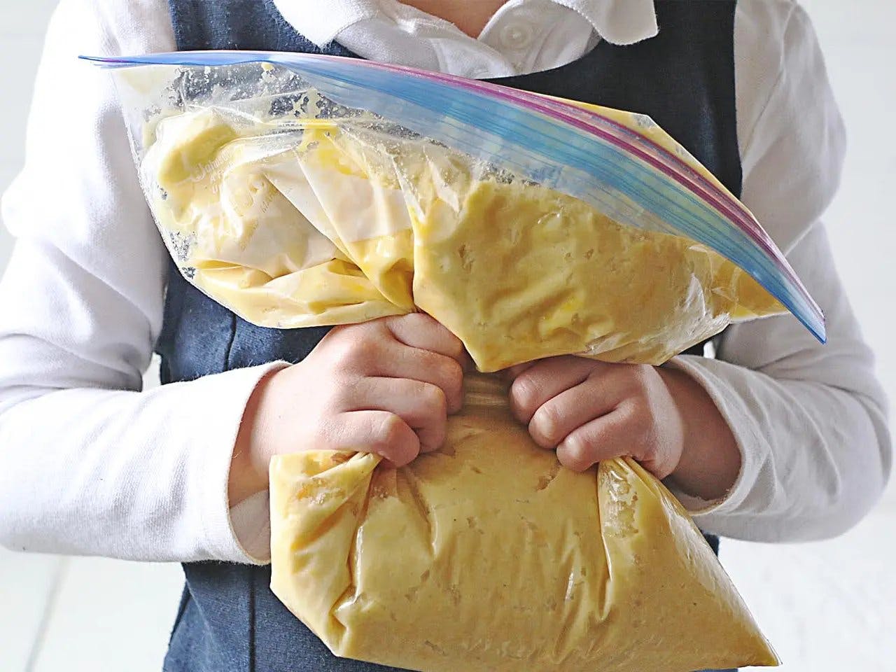 Person kneading Ziploc bag of gnocchi dough. 